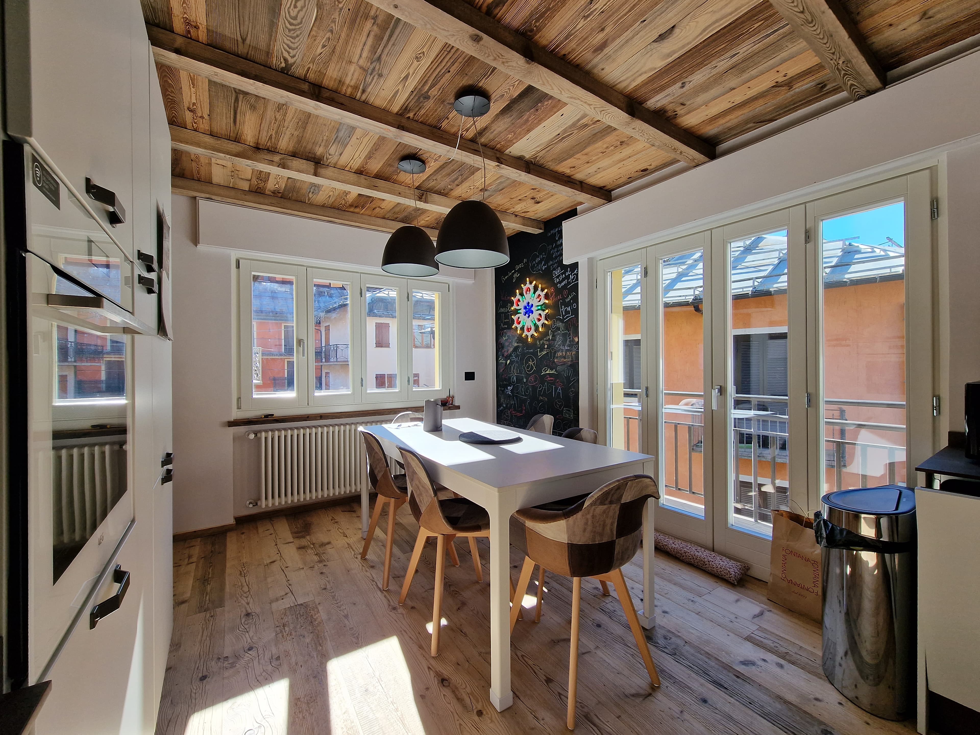 Salle à manger de l'appartement Bijou Limone avec table et cuisine ouverte